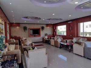 a living room with couches and tables and a tv at ديالا للشقق المخدومة1 in Riyadh