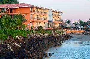 a building on a cliff next to the water at The Beach House in Panama City