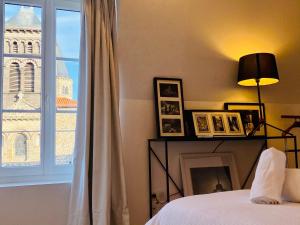 a bedroom with a bed and a window with a tower at Charmant T2 Cosy Notre Dame du Port in Clermont-Ferrand