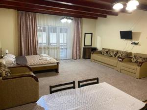 a living room with a couch and a table at Central Courtyard in Slavske