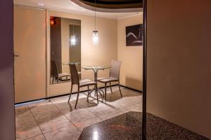 a dining room with a glass table and chairs at Fada Hotel - Motel Adults Only in Recife