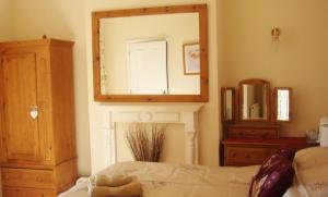 A bed or beds in a room at Harlequin Guest House with parking 