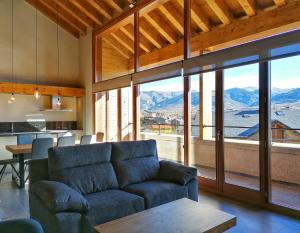 a living room with a couch and a table at Apartament "El Castell" Casa Rural Cal Rialla in Llivia