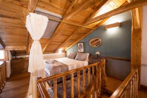 a bedroom with a bed and a wooden ceiling at Four Season Maison in Kavala
