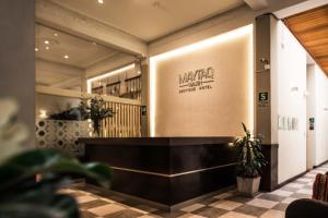 a lobby of a hotel with a counter and plants at Maytaq Wasin Boutique Hotel in Cusco