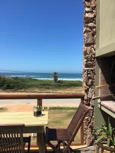 a balcony with a table and a view of the beach at Casa del Mar in La Paloma