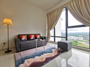 a living room with a couch and a large window at Mid Valley Southkey Mosaic Cozy Suite at Johor Bahru in Johor Bahru +67 photos