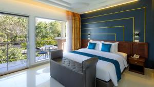 a bedroom with a large bed and a balcony at ARAYA HOTEL in Uttaradit