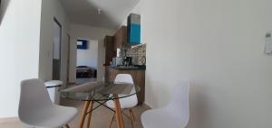 a dining room with a table and white chairs at Loft 10 min from Oro &Holy Beach, Marina, Galerias in Puerto Vallarta
