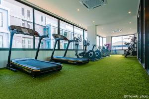 a gym with several treadmills and exercise bikes at Cozy design studio near Nai Harn beach in Nai Harn Beach