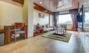 a living room with a table and chairs at Hotel Shree Daan in Vapi