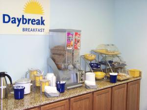 a kitchen counter with a appliance on top of it at Days Inn & Suites by Wyndham Columbus NE in Columbus