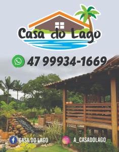 a sign for a csa do lago with a building at Casa do Lago - Pousada & Casas de Temporada in Penha