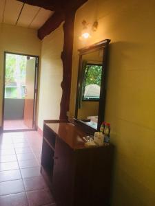 a bathroom with a sink and a mirror on the wall at Koh Ngai Resort in Ko Ngai