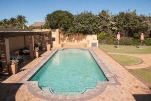 a swimming pool in the middle of a yard at Langebaan Golf Studio B1 - Langebaan Golf Estate in Langebaan