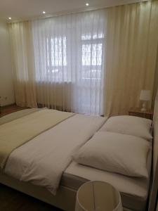 um quarto com uma cama grande e uma janela em Lux Apartment in the City Center em Mukacheve