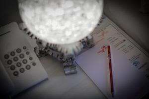 a lamp sitting on a desk next to a calculator at Hotel Rose Petal Srinagar in Srinagar