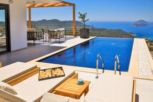 a house with a swimming pool with a view of the ocean at Villa Pastoral in Kas