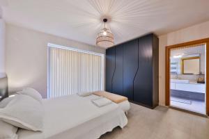 a bedroom with a white bed and a large window at Villa Pastoral in Kas