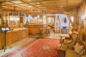 a large room with a kitchen with wooden cabinets and a rug at Appartement- und Wellnesshotel Charlotte - 3 Sterne Superior in Seefeld in Tirol