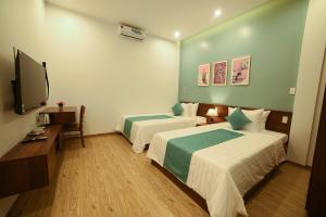 A bed or beds in a room at AnAn Homestay Huế