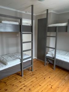 two bunk beds in a room with a wooden floor at Säfsen in Fredriksberg