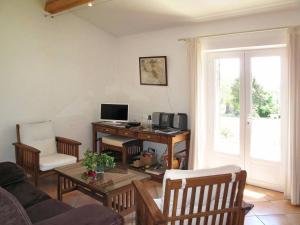 een woonkamer met een bureau en een computer. bij Le Logis, charmant gîte provençal in Ampus