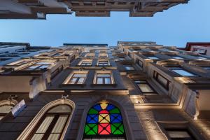 a tall building with a colorful stained glass window at Akka Suites Taksim-Special Class in Istanbul +48 photos