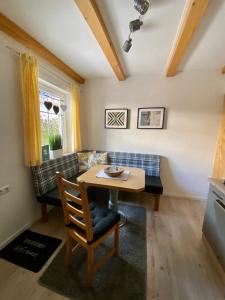 a dining room with a table and a couch at AlpenApartment in Bramberg am Wildkogel