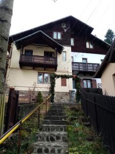 a house with stairs in front of it at Pensiunea Nick in Sinaia