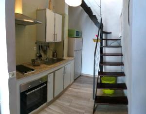 a kitchen with a spiral staircase in a room at Casa Trini in La Mareta