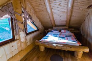 A bed or beds in a room at Forest Glade Cottage - Koča na jasi