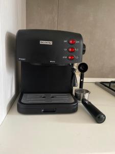 a black coffee maker sitting on a counter at Sweet Home Sara in Ovada