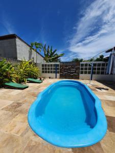 a large blue swimming pool on a patio at The Beach Hostel Milagres in São Miguel dos Milagres