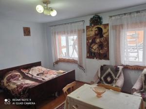 a bedroom with a bed and a table in it at Садиба Брусний in Mykulychyn