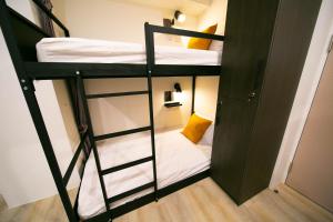 a room with two bunk beds and a closet at Jezreel Inn in Kaohsiung