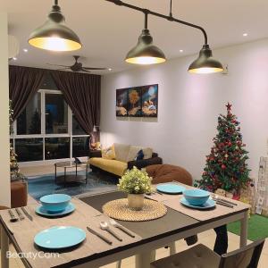 a living room with a table and a christmas tree at KLCC view - Jalan Kuching Boulevard Service Apt in Kuala Lumpur