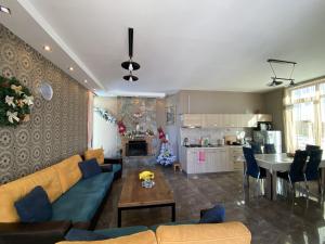 a living room with a couch and a table at Villa Sun Valley in Bakuriani +54 photos