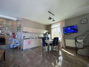 a kitchen with a table and a christmas tree in it at Villa Sun Valley in Bakuriani