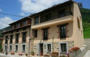 a large building with a balcony on top of it at Mirador De Urriellu in Poo de Cabrales