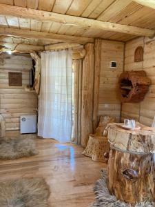 a room in a log cabin with a wooden floor at Pensiunea Angela in Vatra Dornei