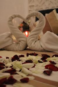a pizza with white toppings and two heart shaped pretzels at Dar Habache in Marrakesh