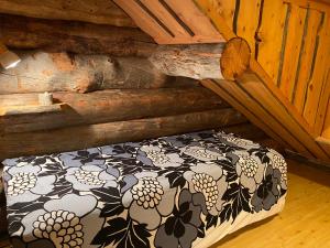 a bedroom with a bed in a log cabin at Levi Log Cabin - Viprakka 4A in Levi