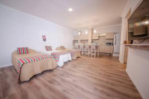 a living room with two beds and a kitchen at Augusta 8 in Salta