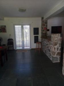 a living room with a fireplace and a stone wall at Camino al Cuadrado in Río Ceballos