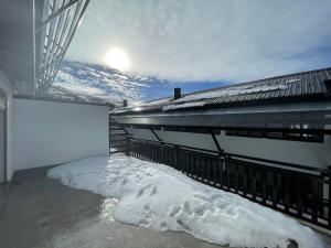 a balcony with snow on the floor of a building at Apartamentos Como en Casa - SN - Macael in Sierra Nevada