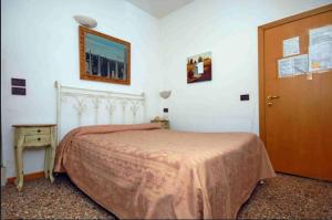 Postel nebo postele na pokoji v ubytování Hotel Antico Capon
