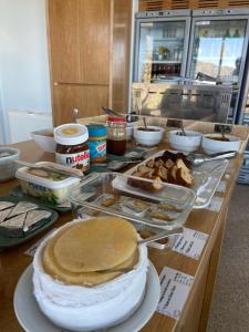 a table with pies and other food items on it at Casas do Pastor in Seia