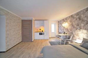 1 dormitorio con cama, mesa y cocina en Затишні апартаменти Bed&Bike en Bila Tserkva