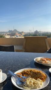 a table with two plates of food on it at Hotel Antra Inn in Jaisalmer